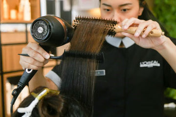 Round brush and dryer creating a blowout