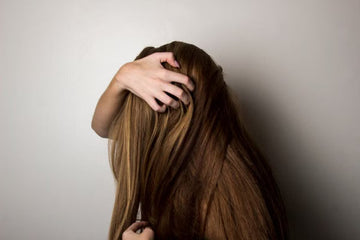 Long, smooth hair held gently in the hand