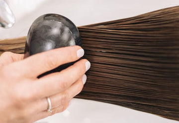 Long hair being brushed through after a treatment