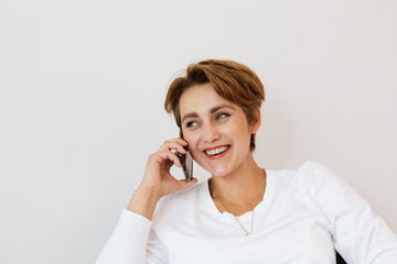 Woman with a short haircut smiling outdoors