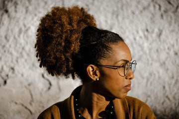 Woman with a curly hairstyle wearing glasses