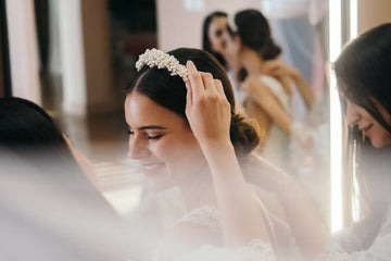Bride having her headband adjusted by bridesmaids