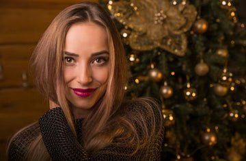 Woman with softly waved hair beside festive lights