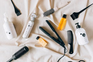 Flat lay of haircare products and styling tools