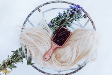 Blonde wig styled with a brush and purple flowers