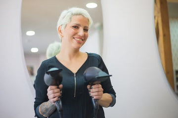 Stylist holding a hairdryer while styling