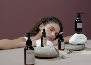 Woman with curly hair beside haircare products