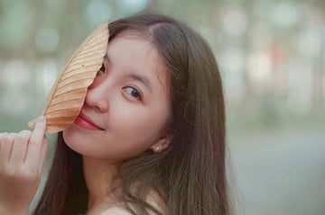 Woman examining the ends of her long hair
