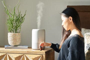 Woman beside a humidifier in a bright room