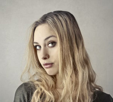 Woman facing the camera with long hair framing her face