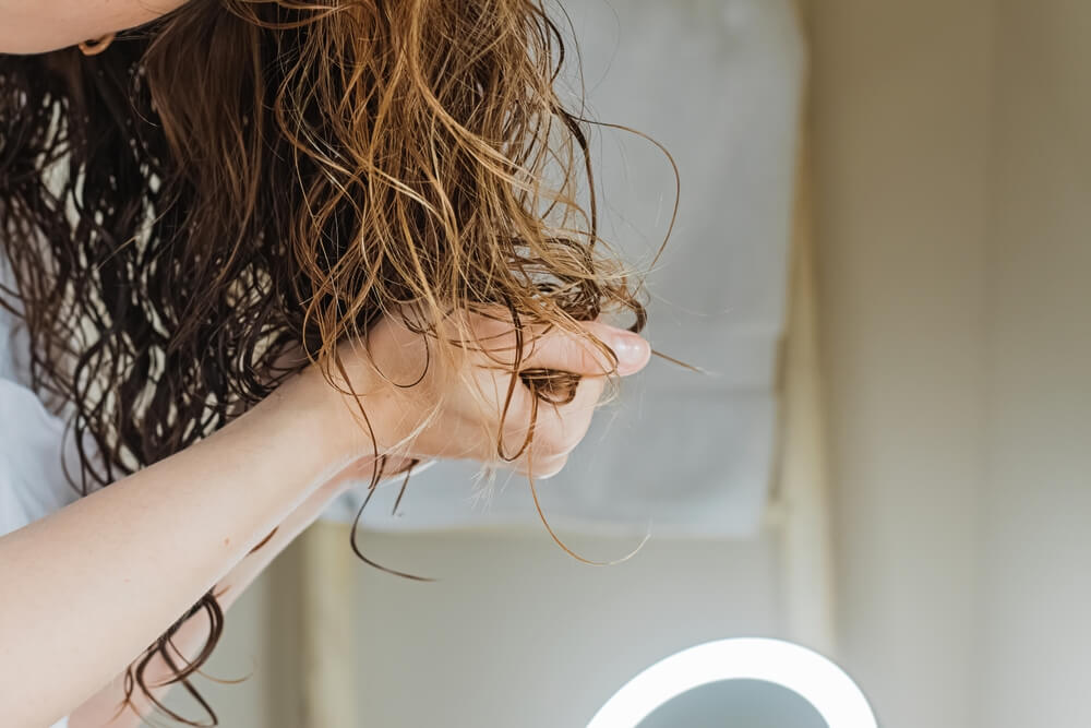 woman styling hair